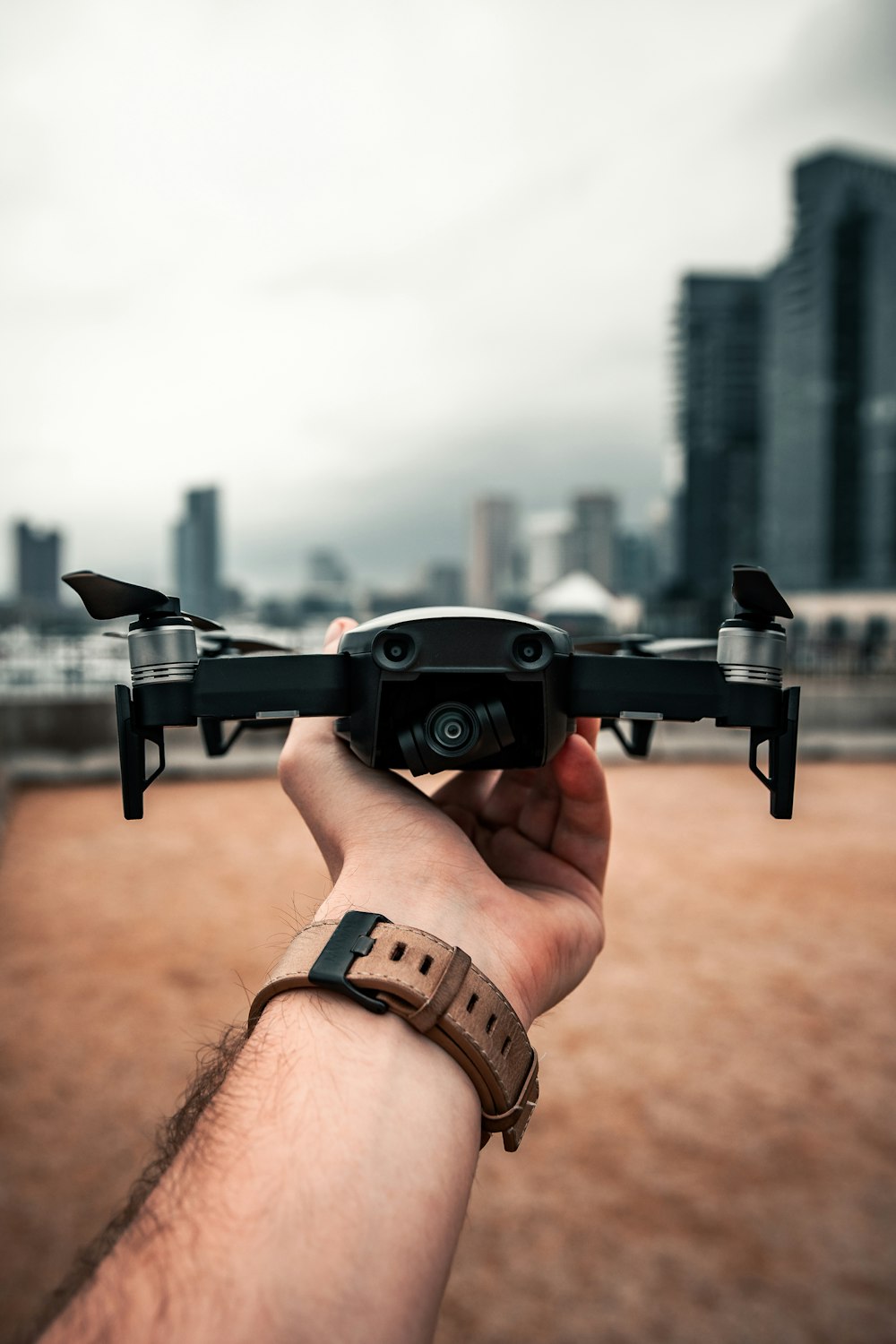 black quadcopter on persons hand