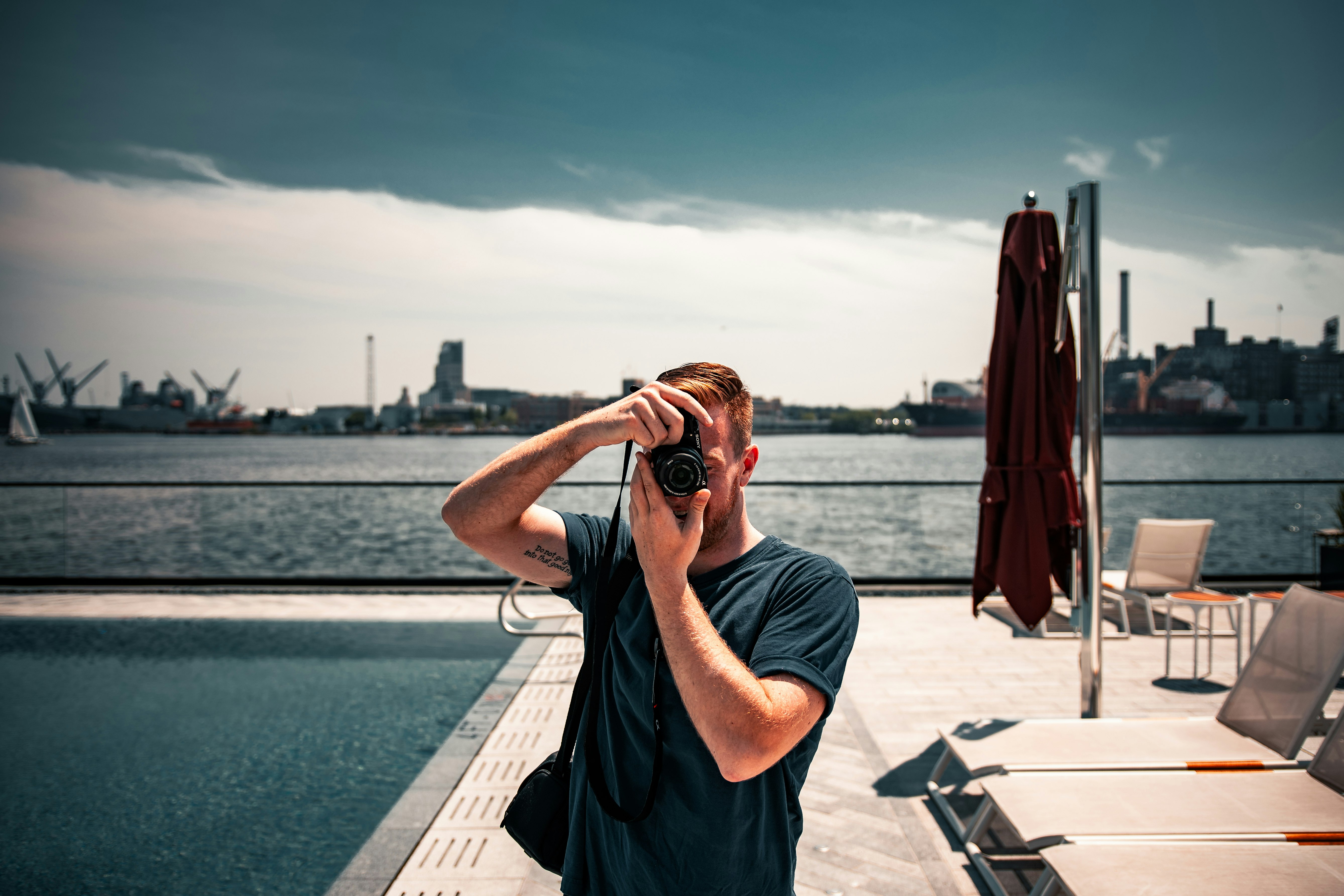 man in black t-shirt standing near body of water during daytime