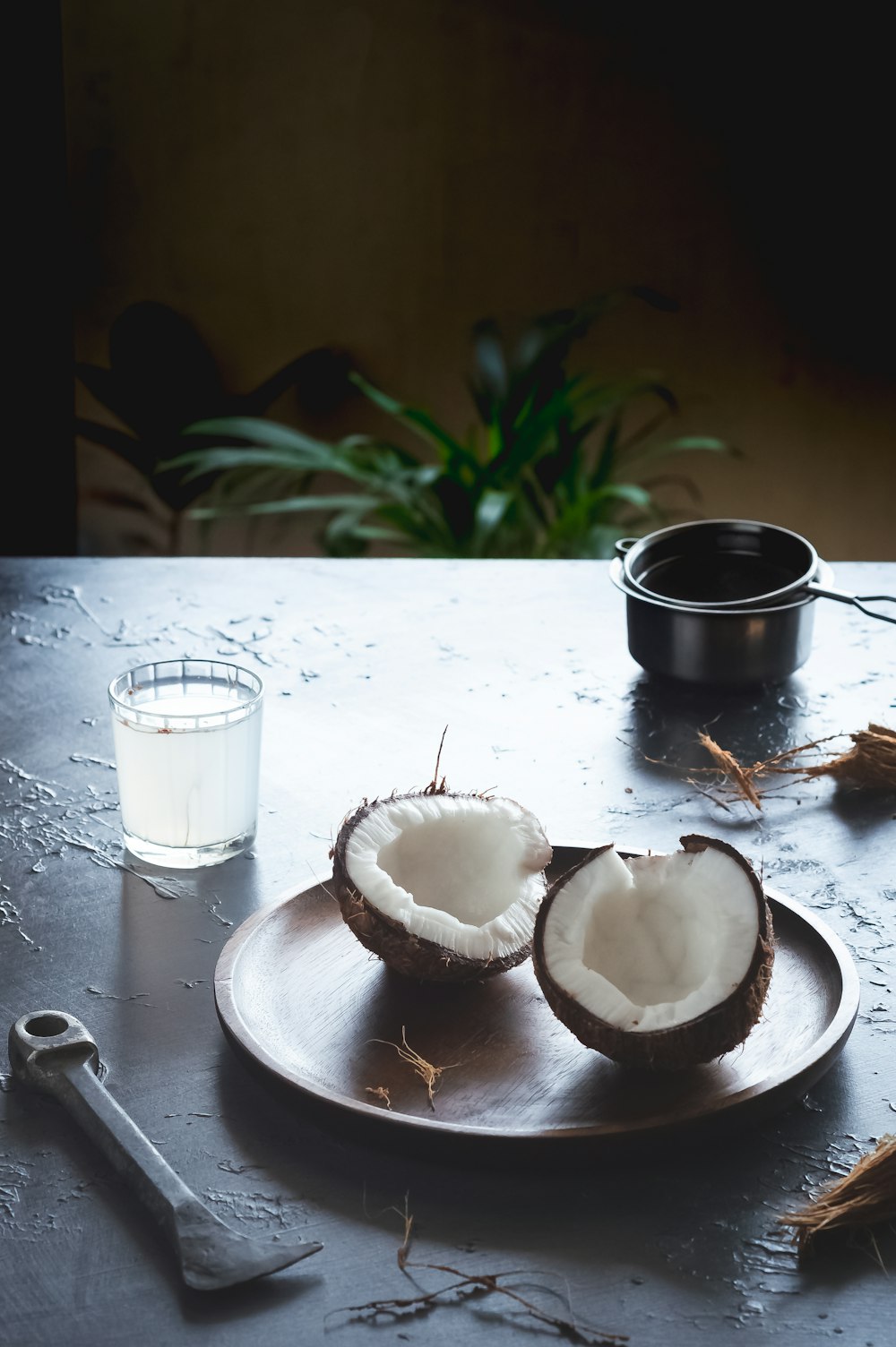 sliced apple beside black ceramic mug on white wooden table