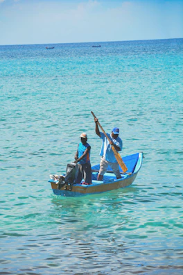 Couple enjoying a boat ride on crystal-clear turquoise waters.
