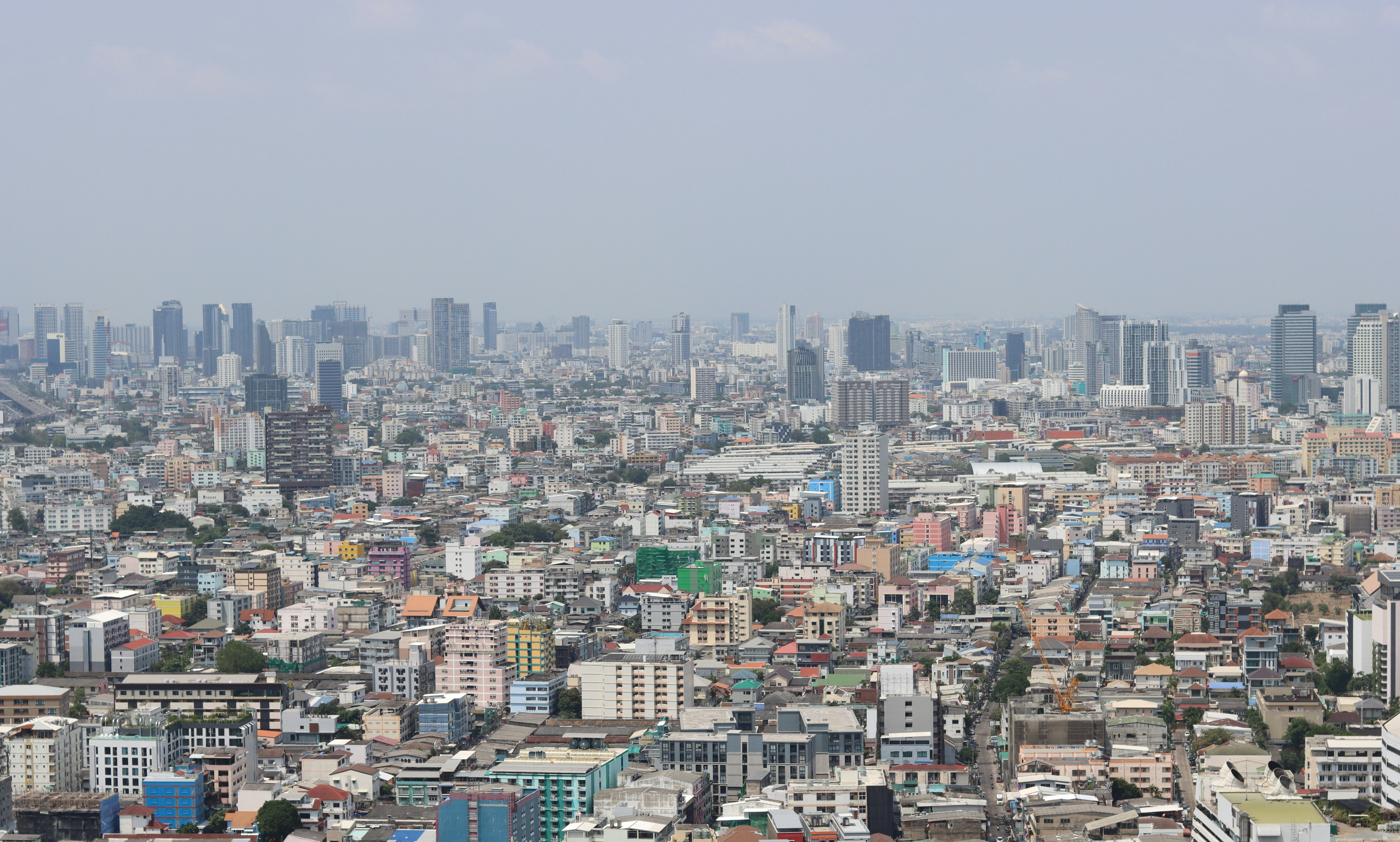 city with high rise buildings under white sky during daytime