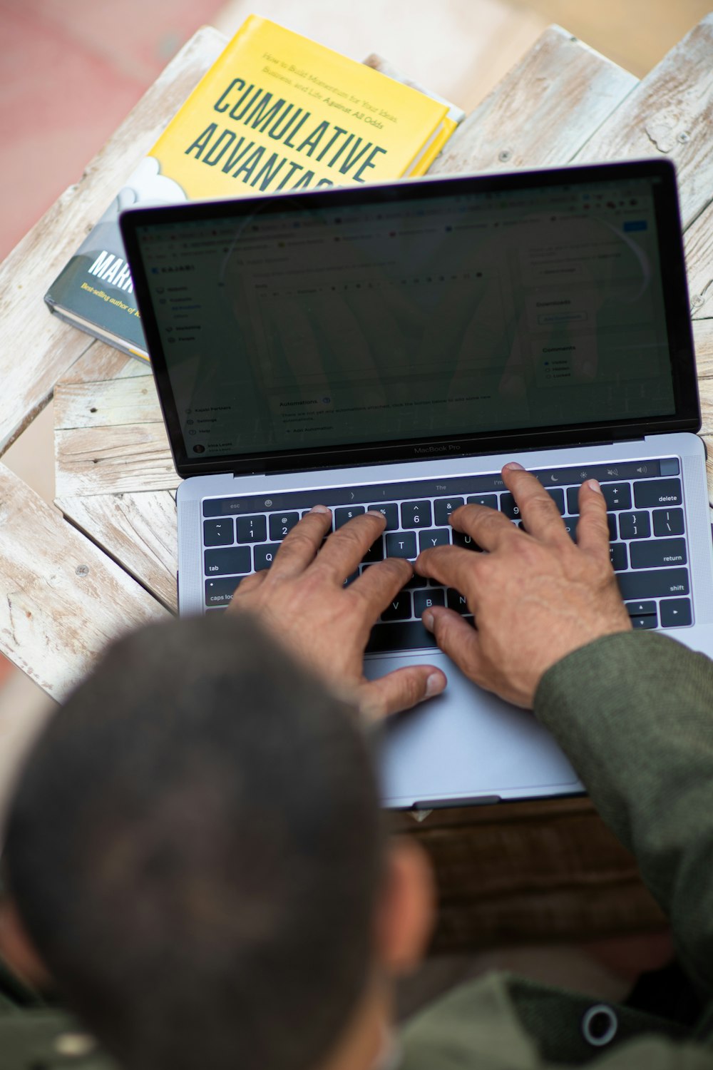 person using macbook pro on table