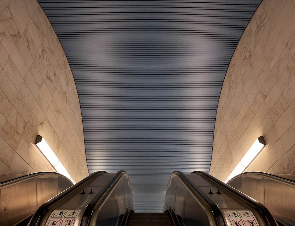gray escalator inside a building