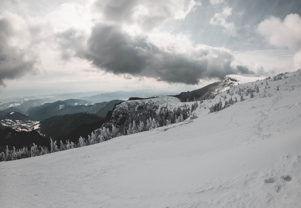 snow covered mountain under cloudy sky during daytime