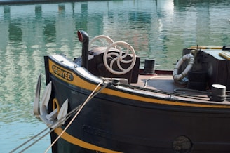 black and brown boat on water during daytime