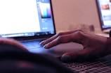 Close-up of hands interacting with a business app on a laptop