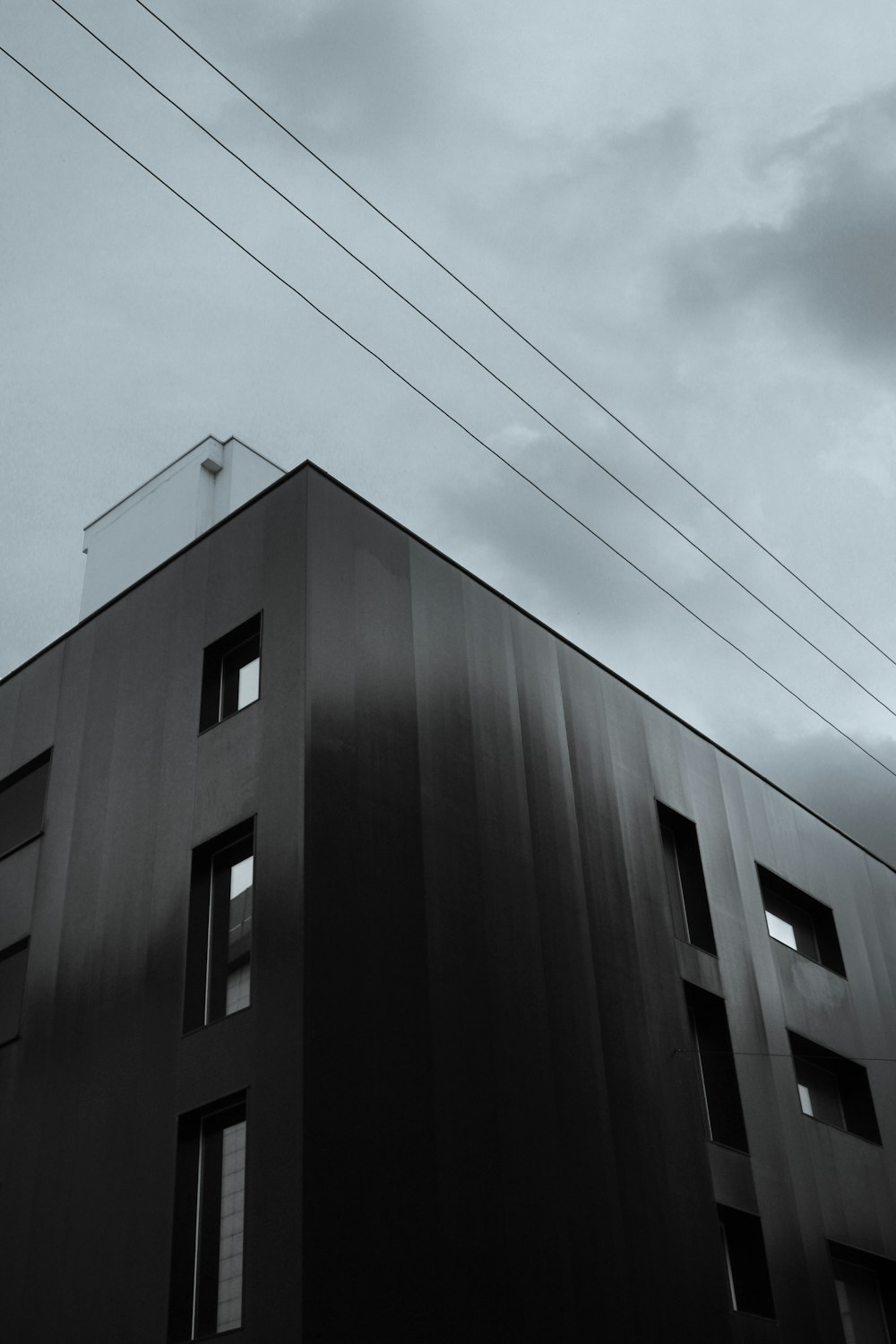 brown concrete building under white clouds during daytime