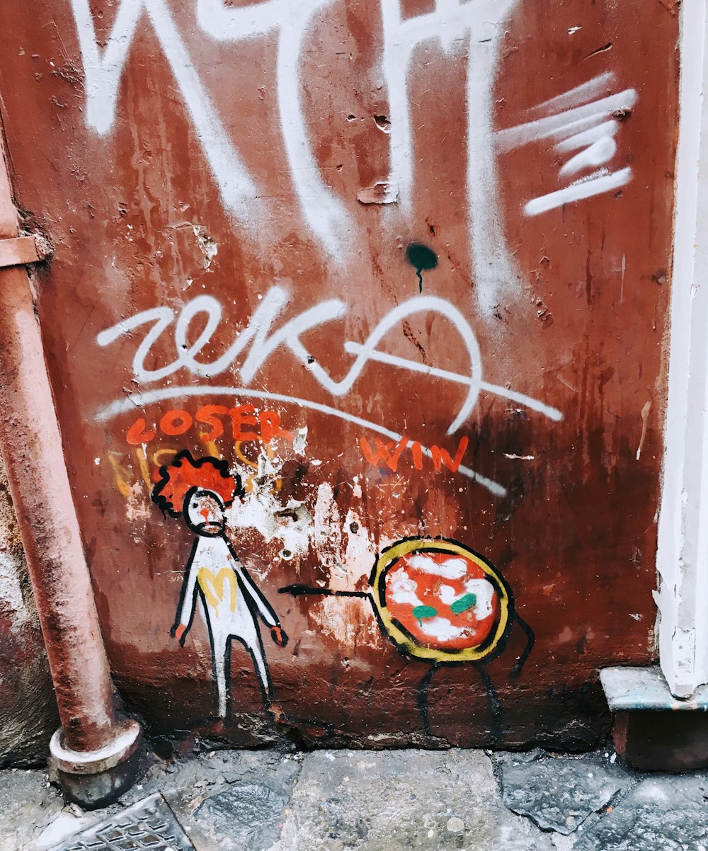 red and white wall with graffiti