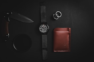 black leather strap silver round analog watch and brown leather bifold wallet