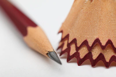 Close-up of a pencil sharpening over an empty sketchbook, symbolizing fresh beginnings