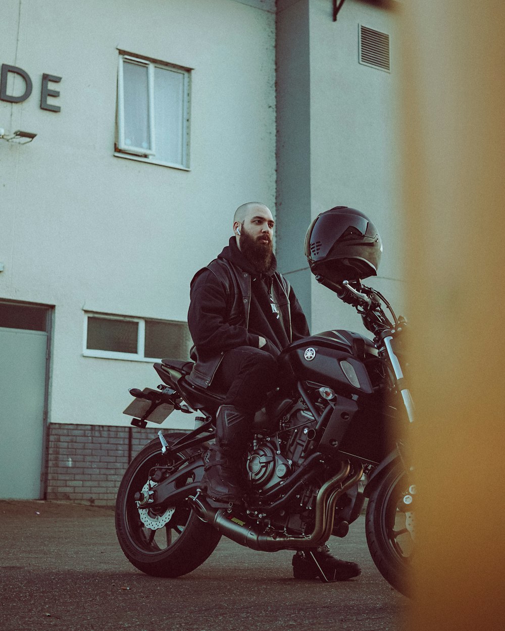 man in black jacket riding red and black motorcycle