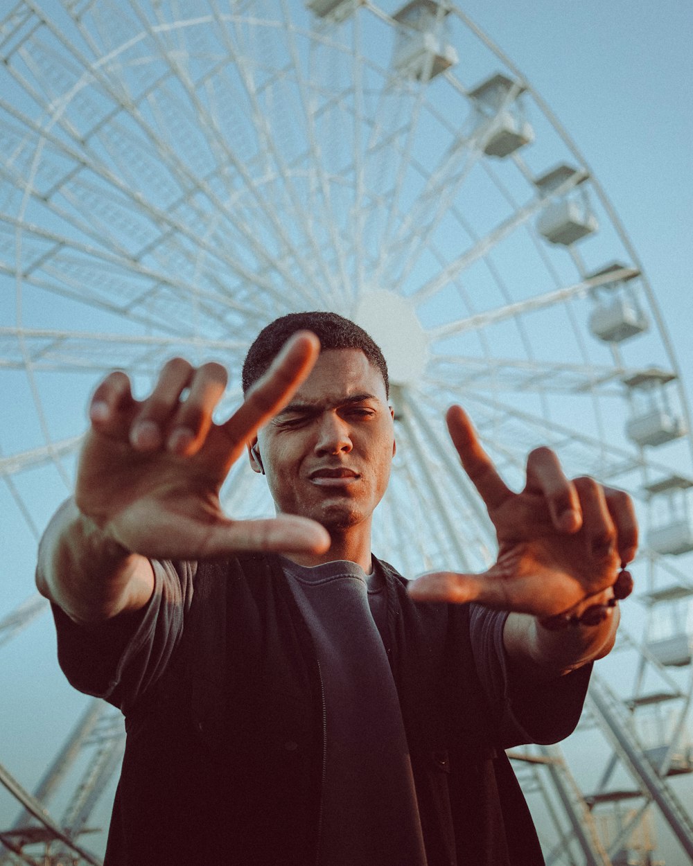 man in black long sleeve shirt raising his hands