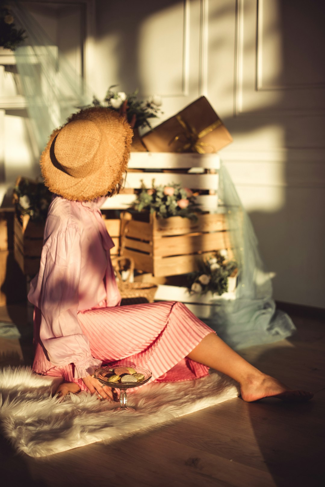 woman in pink and white dress wearing brown woven hat