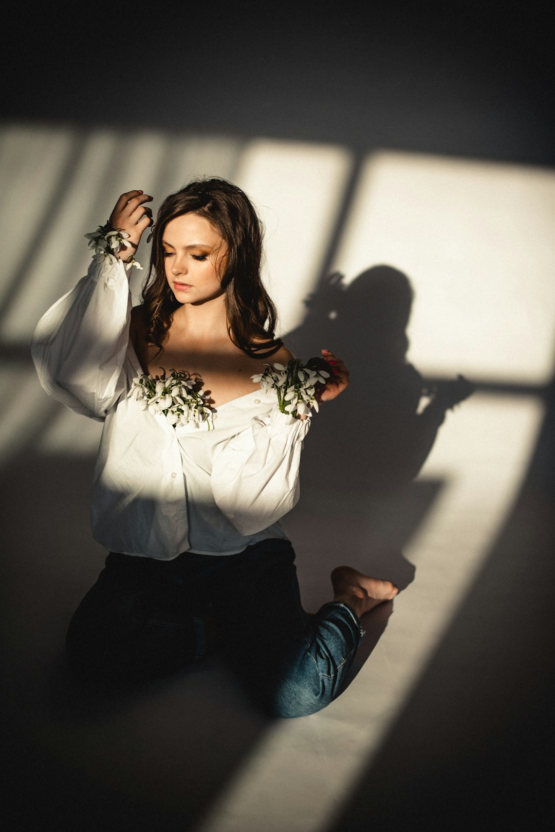 woman in white long sleeve shirt and blue denim jeans