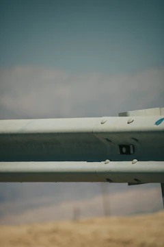 Close-up of galvanized SteelGuard barriers with interlocking hooks and powder-coated finish.