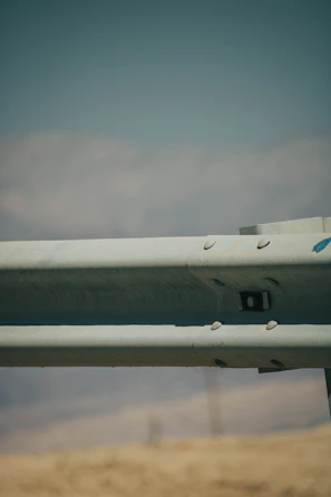 A detailed view of a PRFV pultruded guardrail installed along a busy urban passadiço