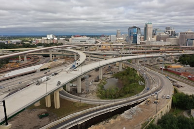 An aerial view of a complex road network under construction with heavy machinery.
