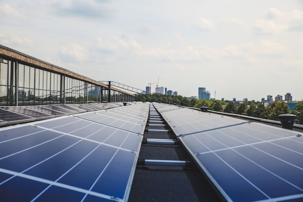 Close-up of eco-friendly cleaning products being applied to solar panels in a city setting.