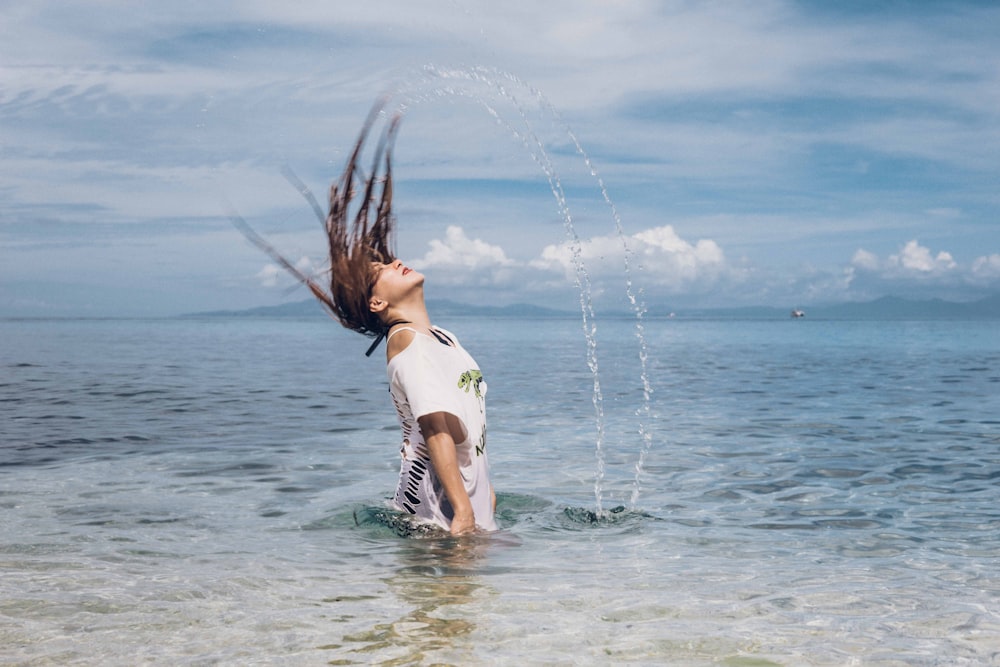 woman in white and black polka dots bikini top on water during daytime