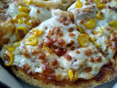 A close-up of a slice of pizza with melted cheese and toppings.