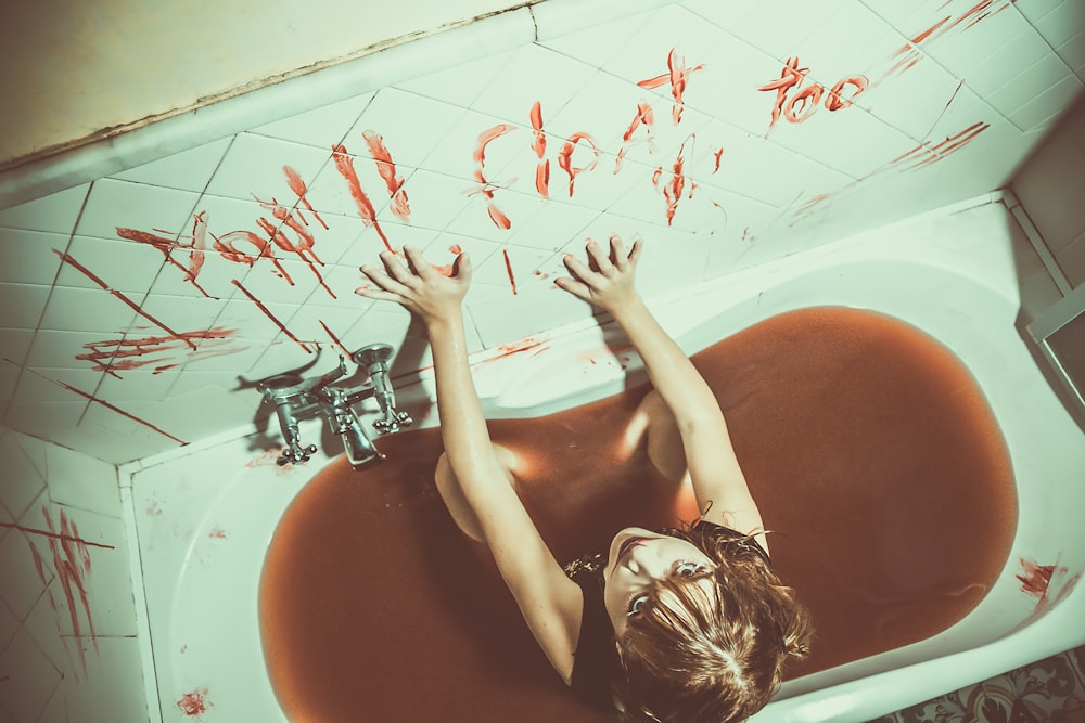 woman in bathtub with red petals