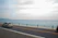 A scenic coastal road in Riviera Nayarit with a comfortable transfer van driving along the shore.