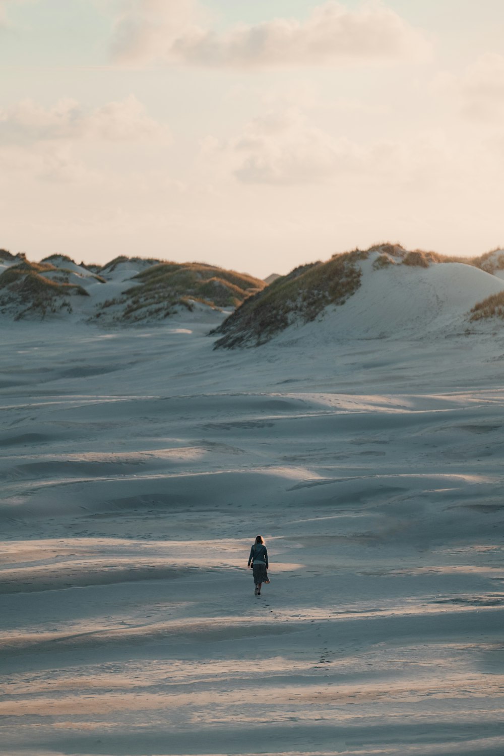 person in black jacket standing on snow covered ground during daytime