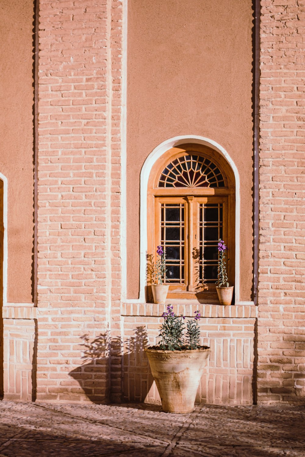 brown wooden door on brown brick building