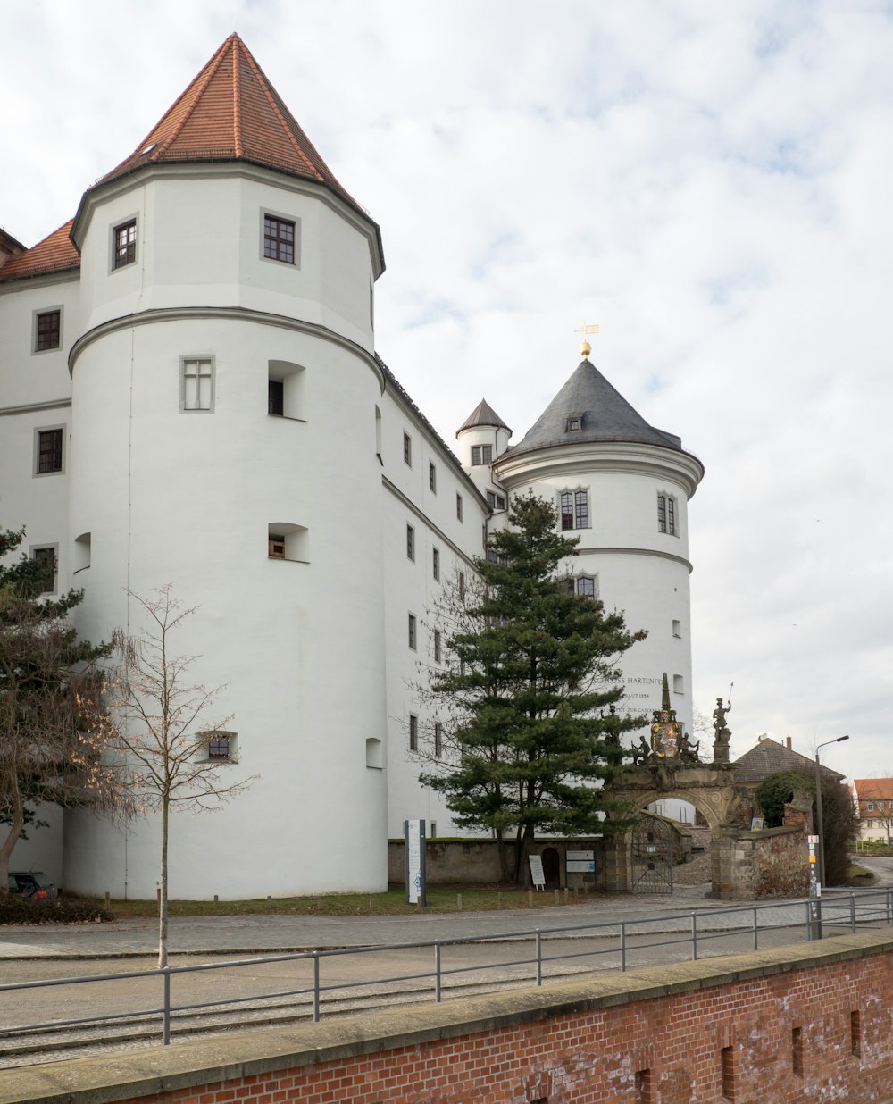 a large white building sitting next to a brick wall