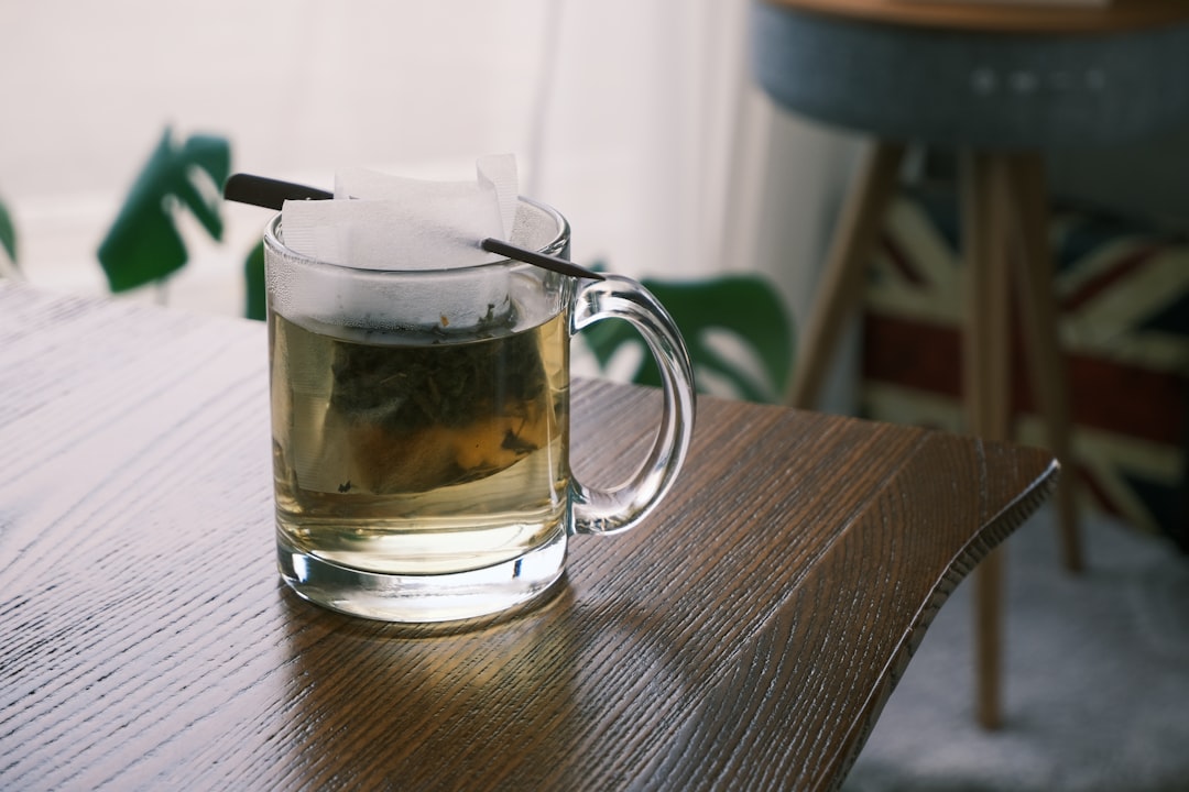 clear glass mug on brown wooden table