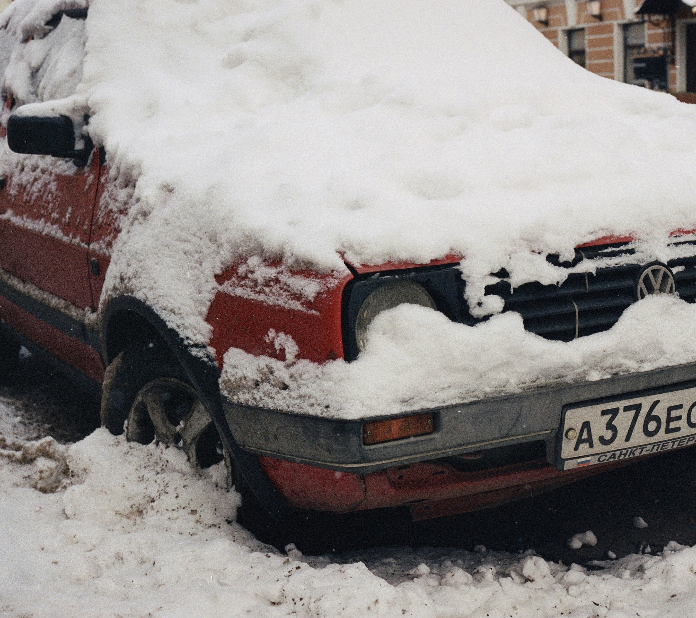 Old VolksWagen under snow