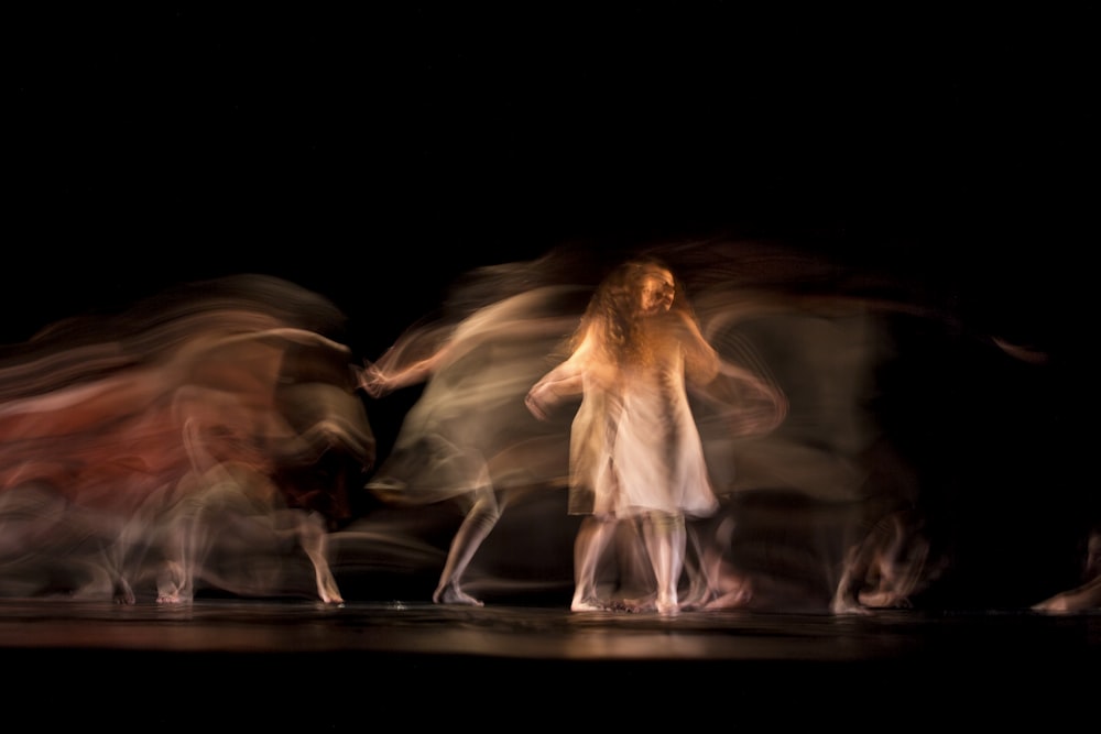 woman in white dress dancing on stage