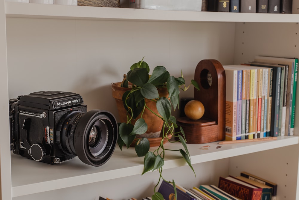 black and silver speaker on white wooden shelf