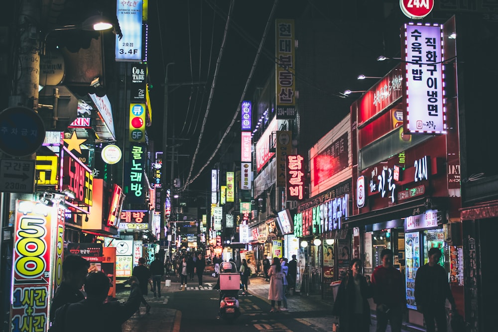 people walking on street during night time