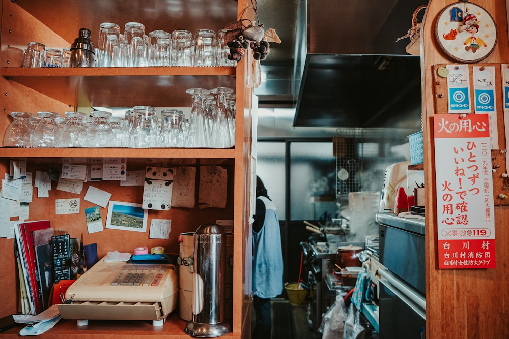 clear glass bottles on brown wooden shelf