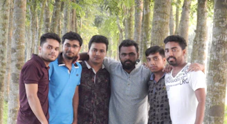 A group of men walking from shadowed woods into bright sunlight, symbolizing transformation and brotherhood.
