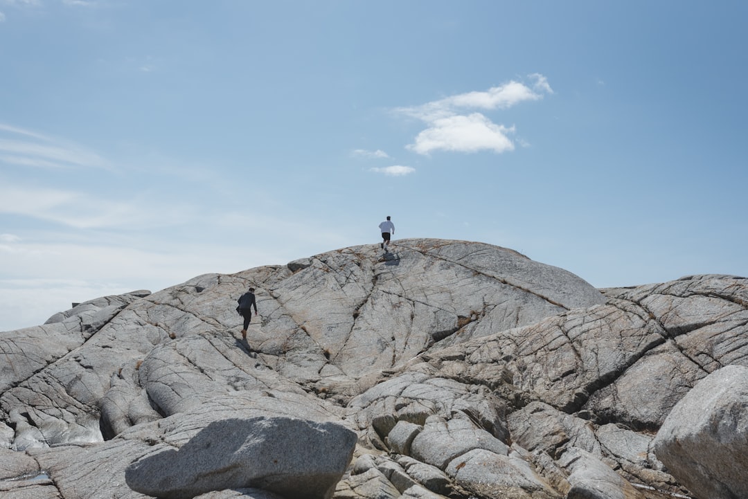 person standing on rocky mountain during daytime