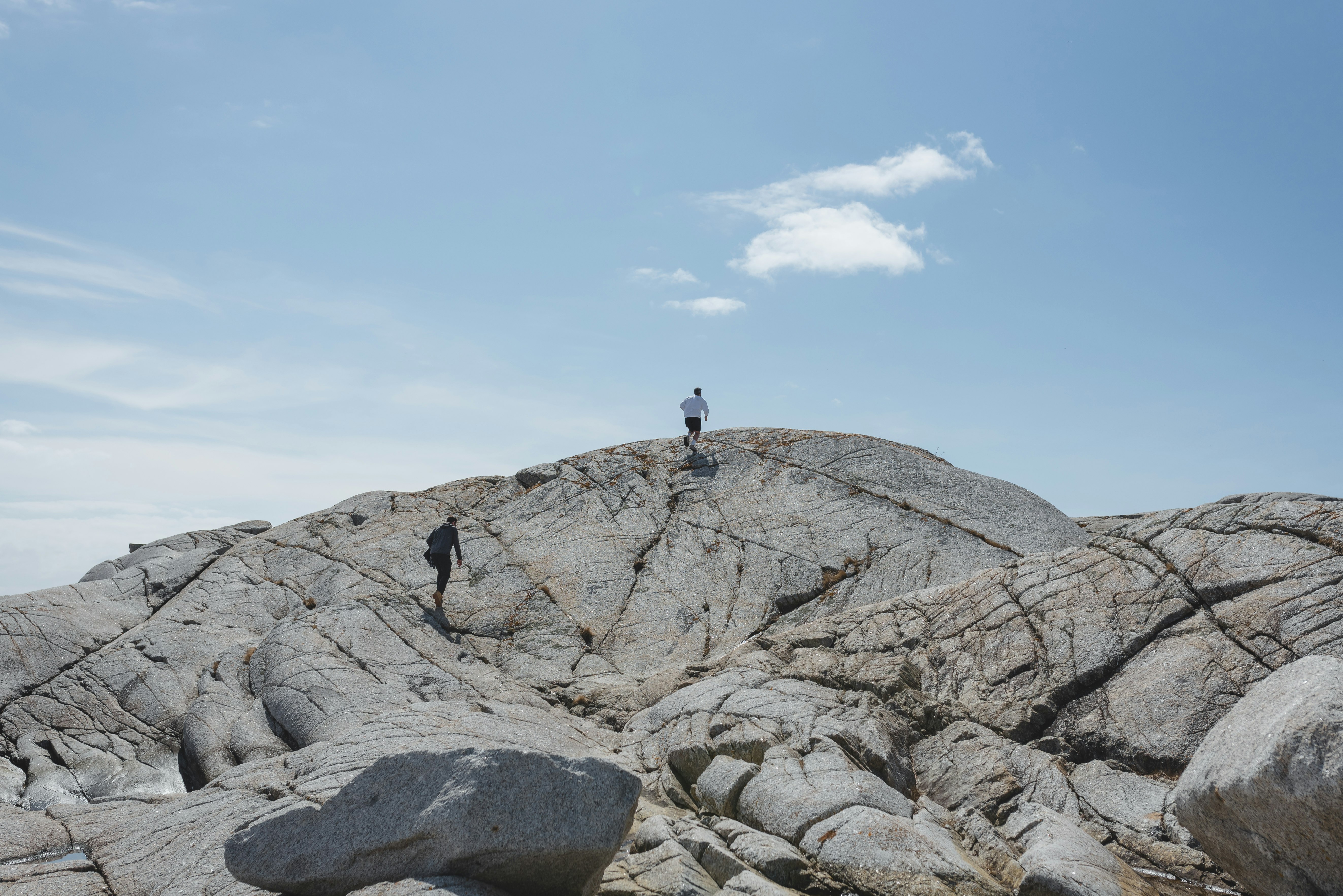 person standing on rocky mountain during daytime