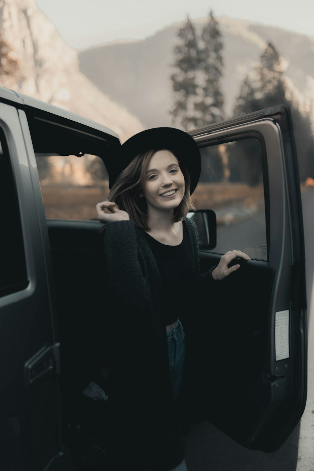woman in black long sleeve shirt sitting on car seat