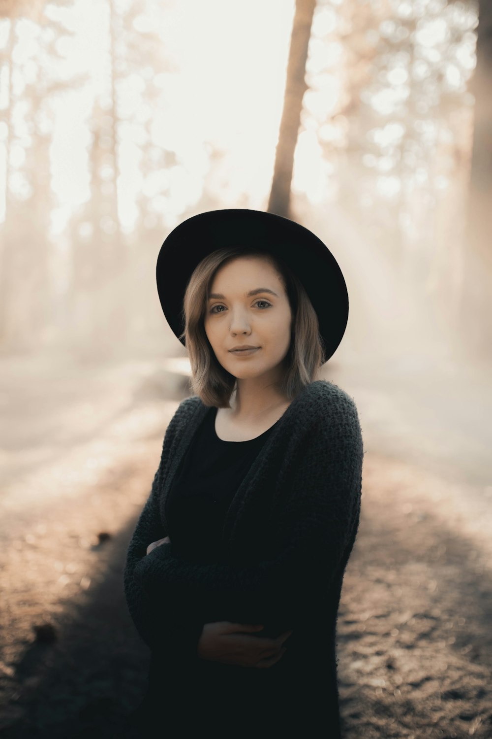 woman in black sweater wearing black hat