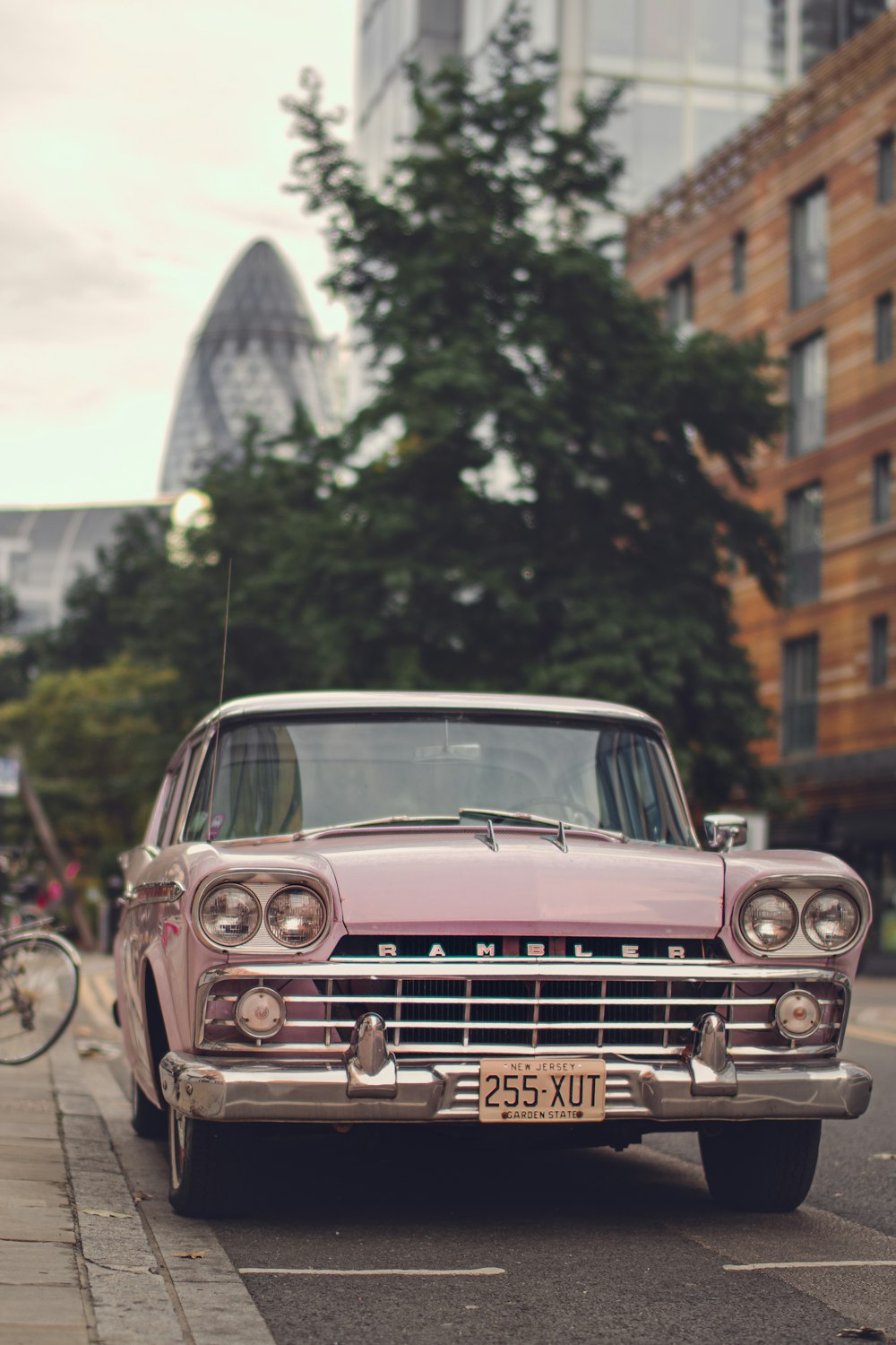 white classic car in front of building