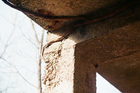 Close-up of a reinforced concrete structure undergoing cathodic corrosion protection treatment.
