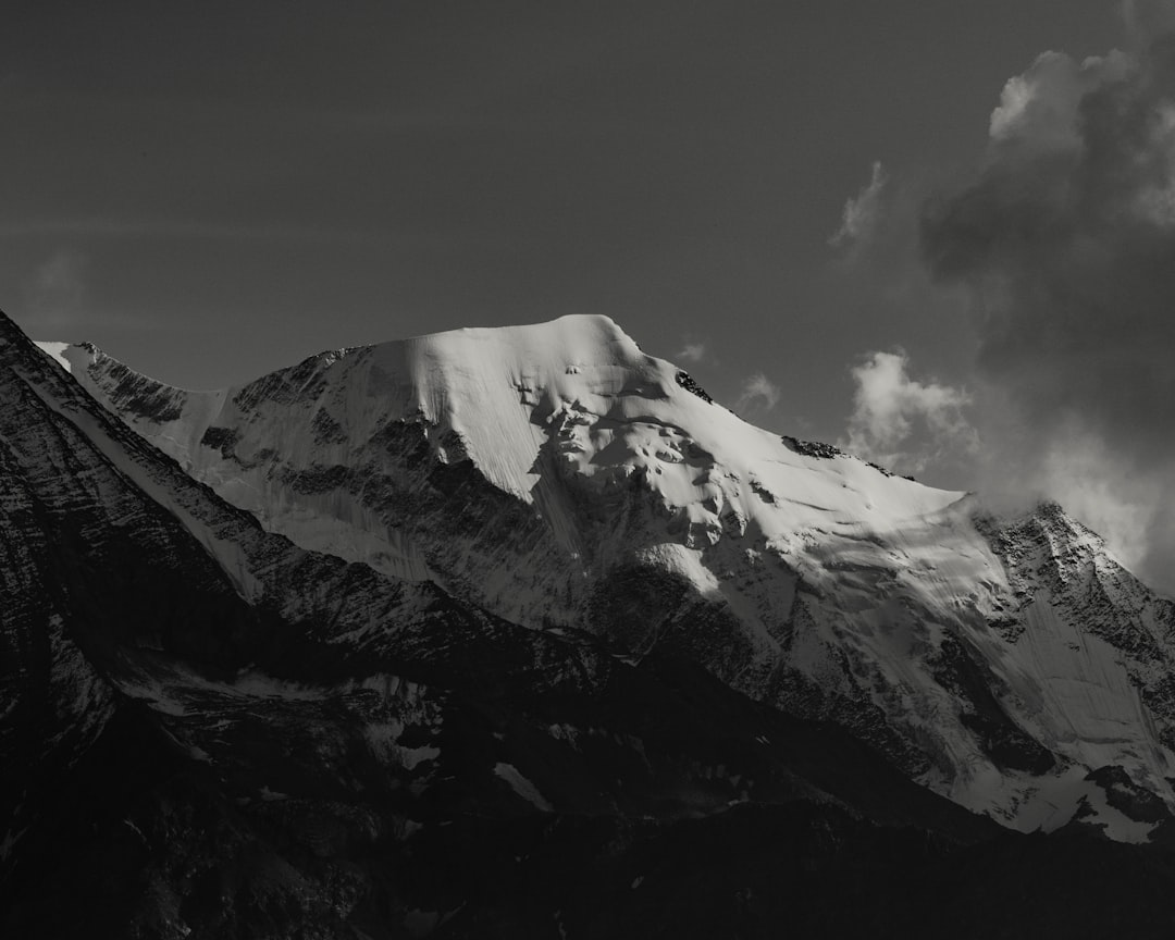 snow covered mountain under cloudy sky during daytime