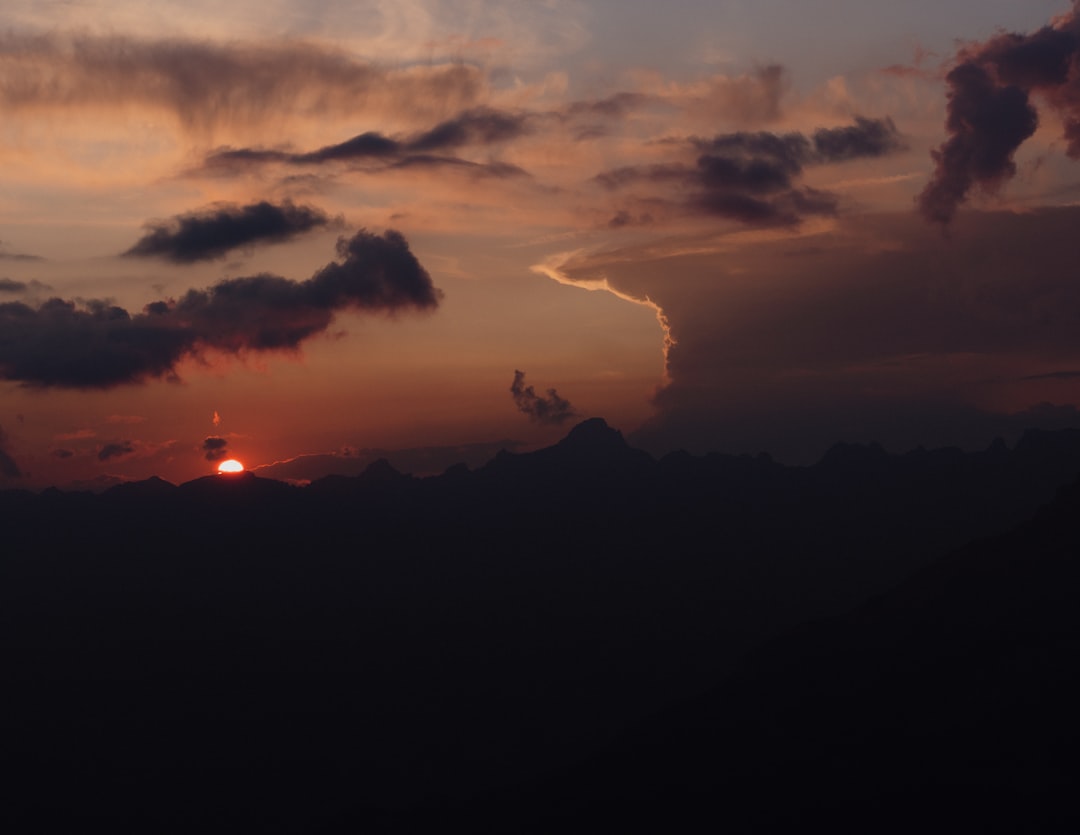 sun covered by clouds during sunset