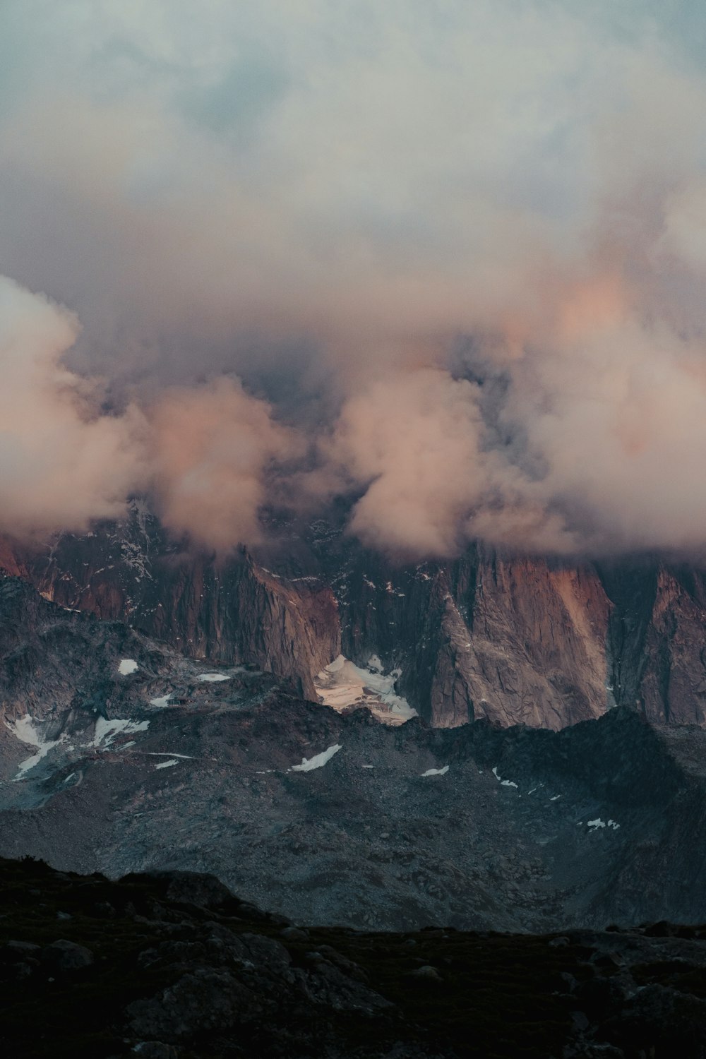 brown and white mountain under white clouds