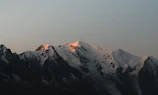 Snow-capped mountains glowing softly in the early morning light.