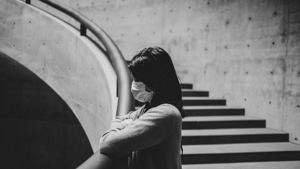 woman in black shirt sitting on stairs