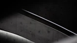 Detail shot of an industrial-style iron handrail mounted on a concrete staircase.