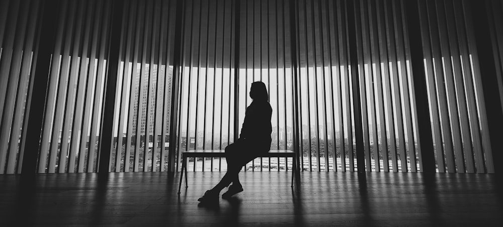 silhouette of person standing near window