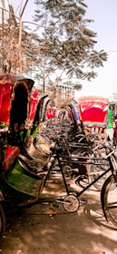 A row of shiny electric rickshaws charging under the sun, ready for the day.